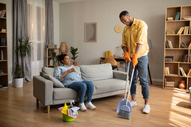 istock African Husband Cleaning House While Wife Using Cellphone At Home 1471478056