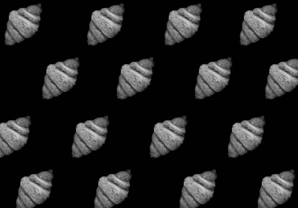 Croissants on the black background. Pattern. Flat lay. Top view.