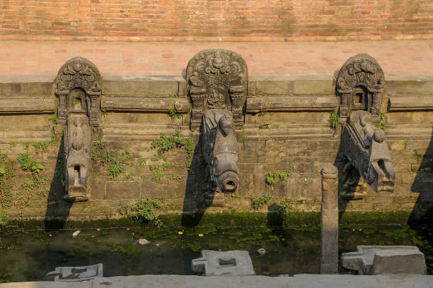 Manga Hiti (Dhunge Dhara) stone water spouts (traditional nepalese drinking fountain) on Patan Durbar Square in  Lalitpur city, Nepal. Soft focus. Architecture feature theme.