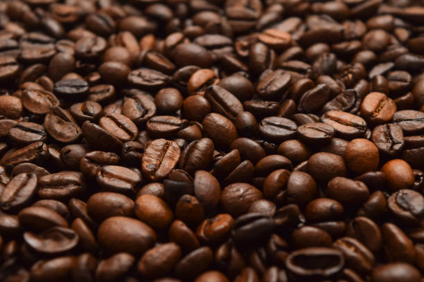 istock Dark roast coffee beans background, top view 1471479696