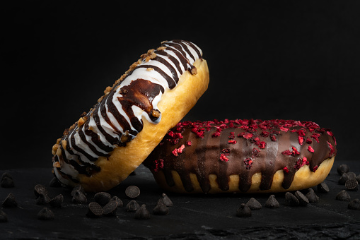 Chocolate donuts on black background