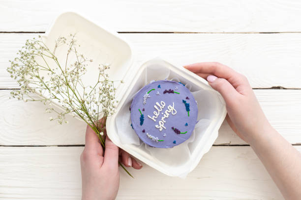 istock Delicious bento cake Hello spring on white wooden background, copy space. 1471480620