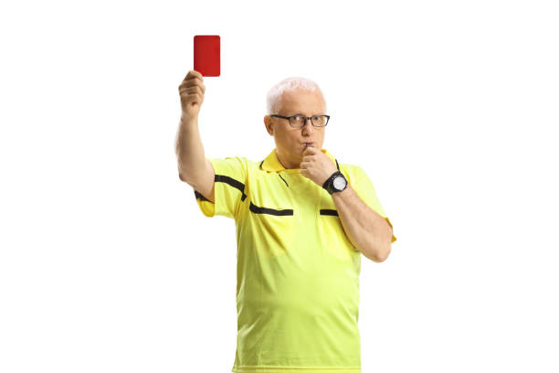 istock Football referee with a whistle showing a red card 1471481747