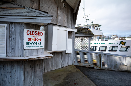 View during the winter of the Island Queen ferry dock and boat that carries passengers to Martha's Vineyard from Falmouth Harbor on Cape Cod in MA.  During the warmer weather months this ferry runs multiple times per day and is very popular with tourists.