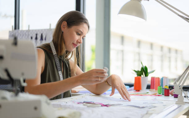 istock Happy female dressmaker working in workshop studio 1471484459
