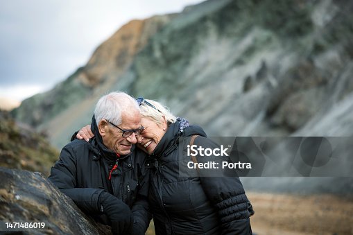 istock Portrait of a loving senior couple hiker on volcanic mountain trail 1471486019