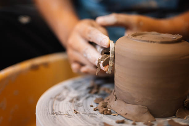 istock Close up on skillful hands sculpting pottery jar on potter wheel 1471486556