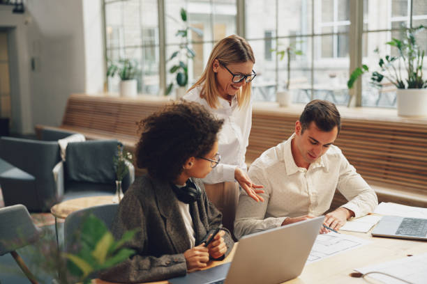 istock Businesspeople working together on new project in modern office. Teamwork concept 1471487273