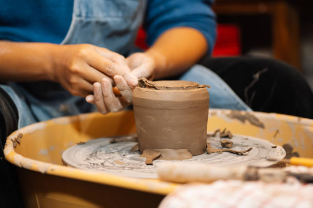 istock Close up on skillful hands sculpting pottery jar on potter wheel 1471487551