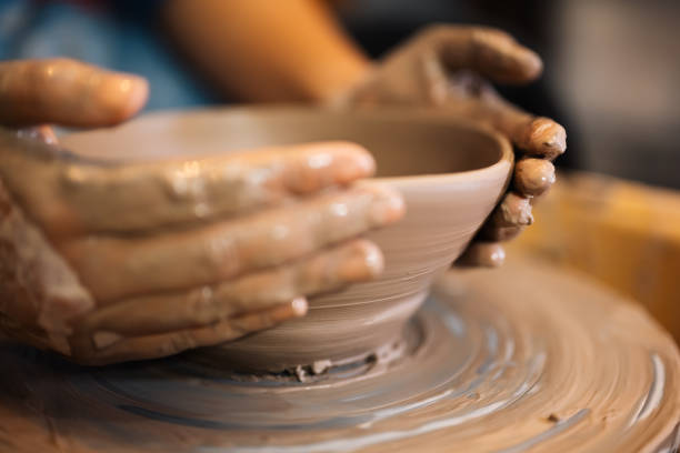 istock Close up on skillful hands sculpting pottery jar on potter wheel 1471488087