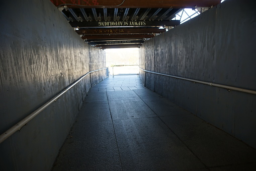 Walking Tunnel to keep pedestrians safe going through a Construction Site with the sunshine coming through at the end, located in Washington, District of Columbia