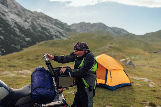 istock The motorcyclist unpacking his things for rest in the mountains 1471489651