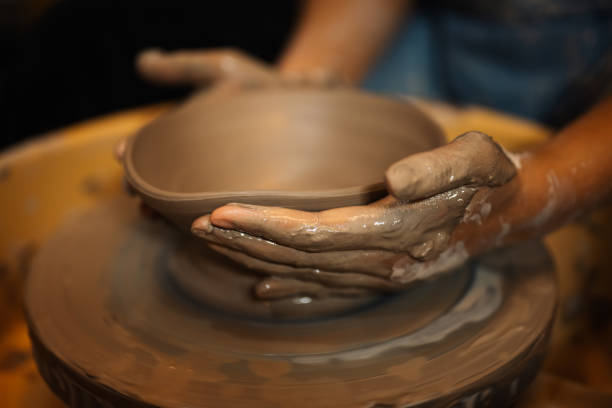 istock Close up on skillful hands sculpting pottery jar on potter wheel 1471490063