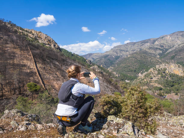 istock Girl taking a photo with mobile in nature 1471490877