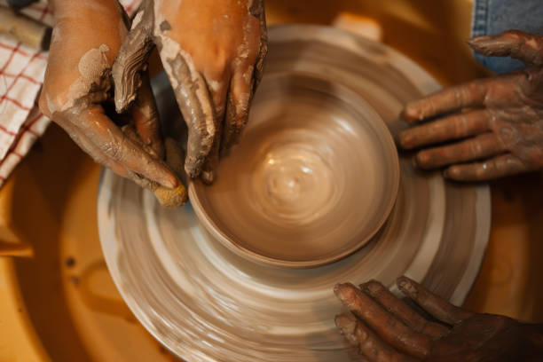 istock Close up on skillful hands sculpting pottery jar on potter wheel 1471491951