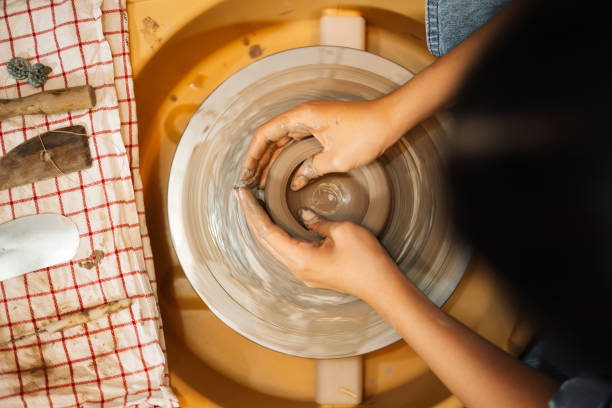 istock Close up on skillful hands sculpting pottery jar on potter wheel 1471492667