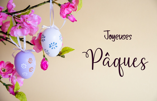 Beautiful Easter Egg Decoration With Spring Flowers. French Text Joyeuses Paques Means Happy Easter. Seasonal Easter Holiday Greeting Card.