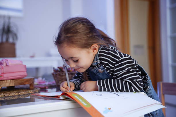 istock Little Cute Girl Drawing With Multicolored Crayons 1471492925