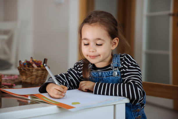 istock Little Cute Girl Drawing With Multicolored Crayons 1471493215
