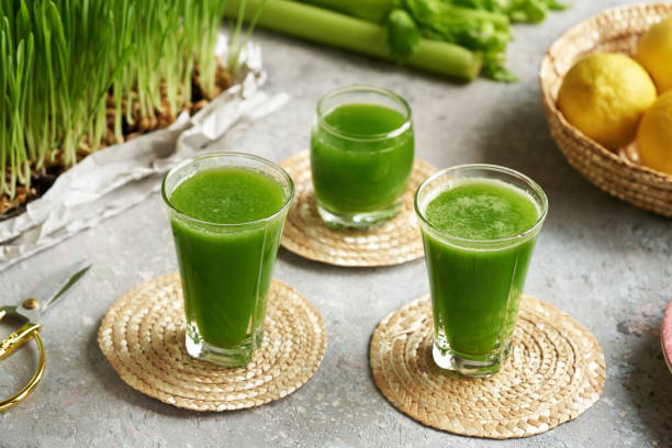 istock Fresh green barley grass juice with fresh homegrown blades on a table 1471493468