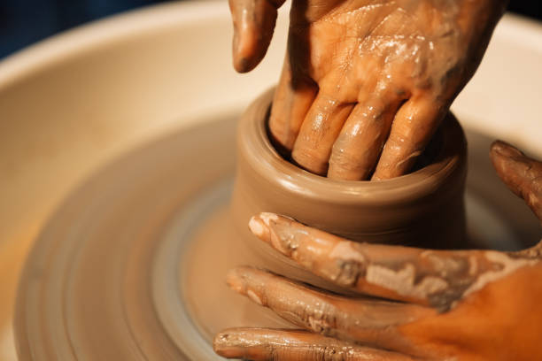 istock Close up on skillful hands sculpting pottery jar on potter wheel 1471494644