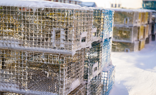 A lobster pot sits unused on a Maine dock during winter in New England