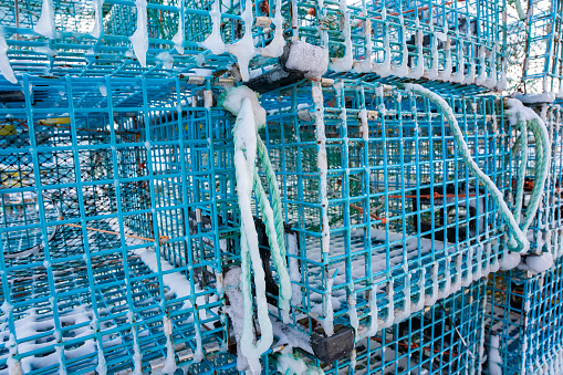 A lobster pot sits unused on a Maine dock during winter in New England