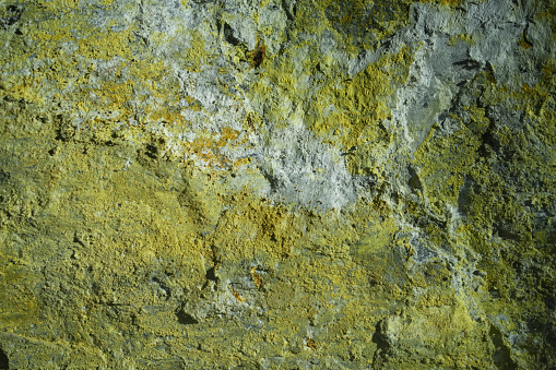 Different colors of minerals on abandoned mine wall. The prevailed minerals are baryte, chalcopyrite, cinnabar, galena and it combines in to nice relief background.