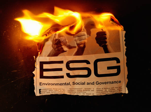 Burning newspaper clipping about ESG (Environmental, Social and Governance), the modern trend in responsible investment. Text was written from scratch by the photographer, who also did the design and took the photo, so this image is free of third-party copyright and may be used without restriction.