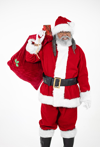 Full length portrait of Santa Claus dancing against white background; copy space  