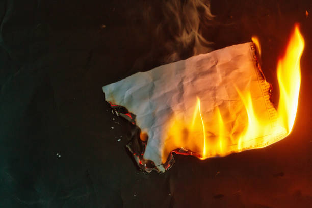 Burning cutting from a newspaper with blank space for your copy