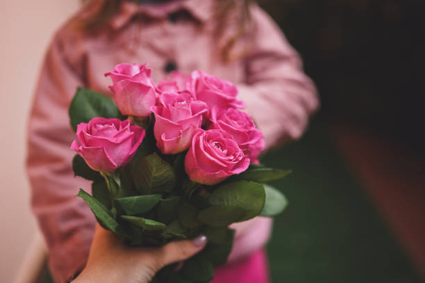 istock unrecognizable child giving flowers to a mother. selective focus. 1471503245