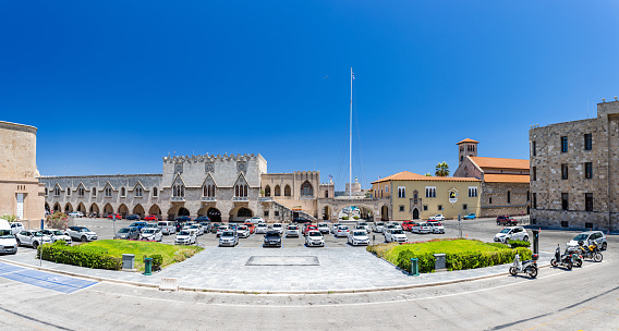 Rhodes, Greece - July 04, 2021: The former Governor's Palace, now used as the the Building of the Prefecture. A panoramic view of the square in front of the Town Hall of Rhodes.