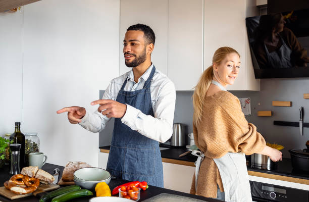 istock Young couple preparing food in the kitchen 1471507745