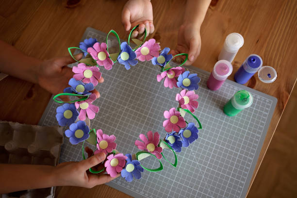 istock Kids create Easter flower wreath in pastel colors using an upcycled egg trail. Zero waste lifestyle 1471508064