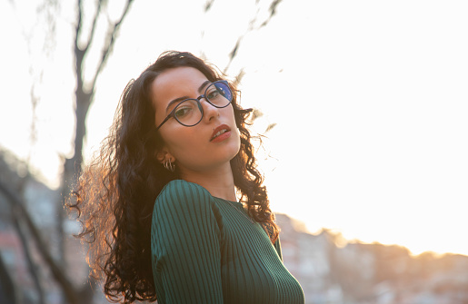Portrait of a beautiful young brunette woman with glasses