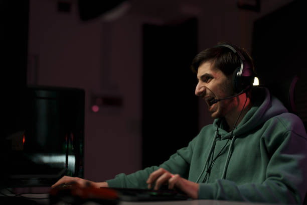 istock Male cybersport gamer screaming while playing video game 1471510027