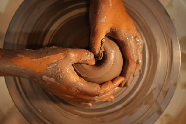 istock Close up on skillful hands sculpting pottery jar on potter wheel 1471511668