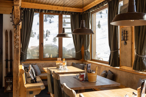 istock Illuminated by bright morning sunlight, the hall of the restaurant with panoramic windows and snow on the windowsills 1471514665
