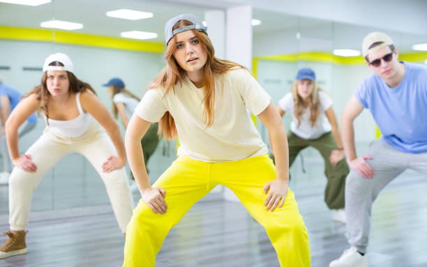 istock Young girl in cap training breakdance Toprock moves in dance hall 1471517962