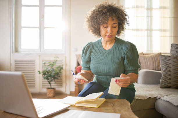 istock Mature woman going through paperwork 1471519747