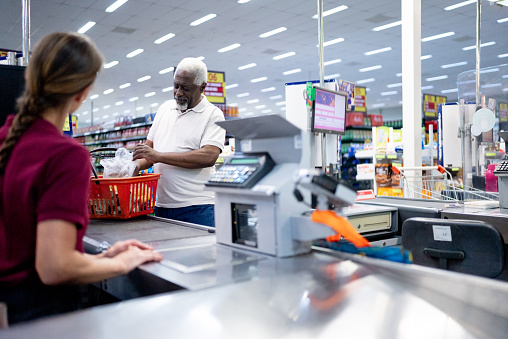 Senior man in the cashier in the supermarket