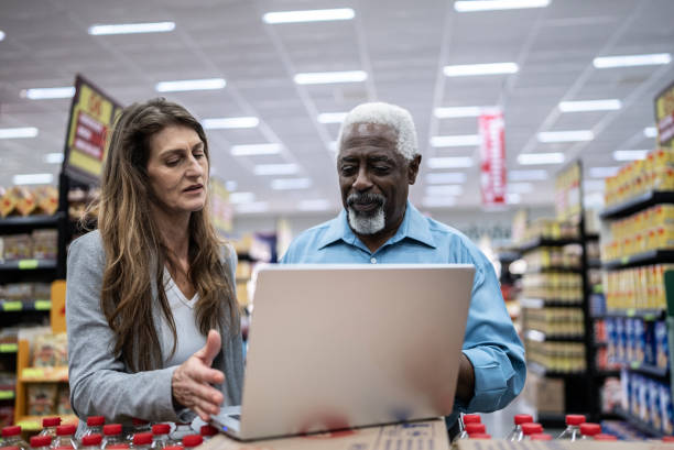 istock Coworkers talking while using the laptop in the supermarket 1471522310