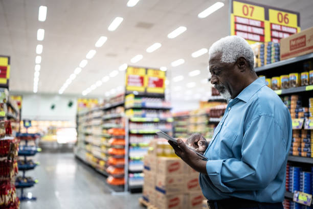 istock Senior man using on the digital tablet in the supermarket 1471522694