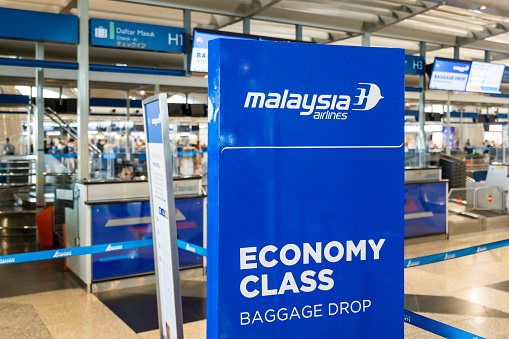 Kuala Lumpur, Malaysia - December 2022: Malaysia Airlines check-in counter with logo at Kuala Lumpur International Airport, Malaysia. Malaysia Airline