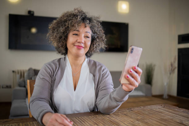 istock Happy mature woman using phone 1471525462