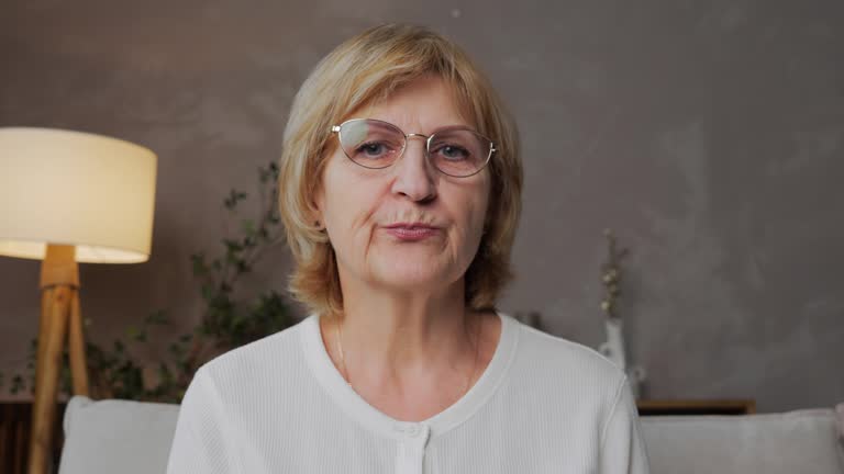 an-elderly-woman-in-a-home-interior-looks-into-the-camera-during-her-learning.jpg?s=640x640&k=20&c=1uFQZhwprqq_BTajgPLv3w1NglDkxV06ufwBCzCyDYE=