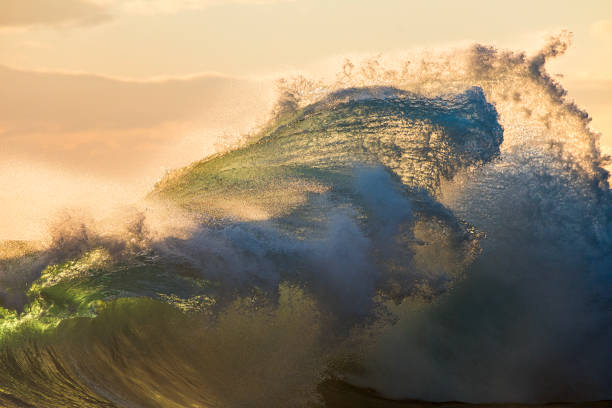 istock Powerful display of ocean waves colliding creating pattern in early morning golden light 1471529681