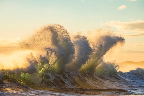 istock Powerful display of ocean waves colliding creating pattern in early morning golden light 1471529712