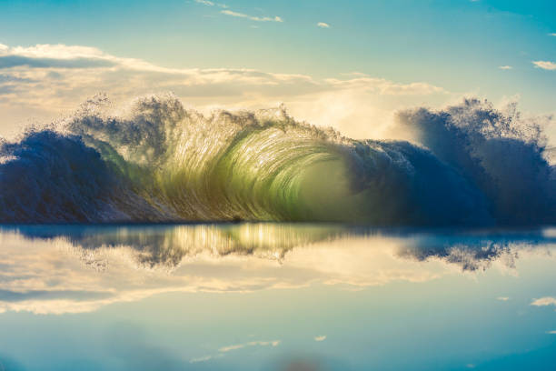 istock Unique display of ocean waves colliding creating pattern in early morning golden light with reflection 1471529775